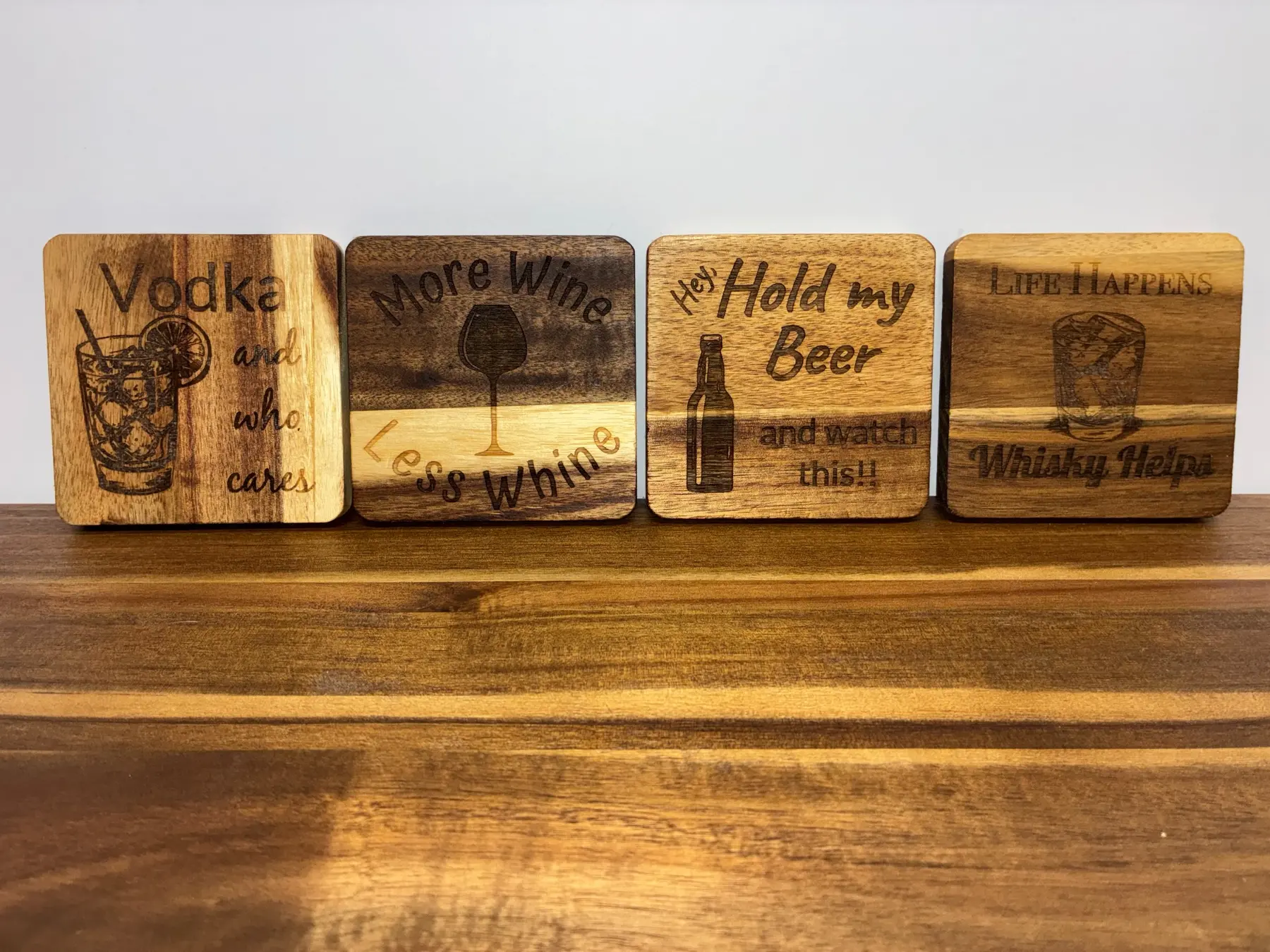 Set of four funny laser-engraved acacia wood drink coasters