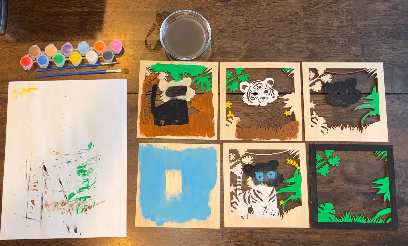 Baby tiger wooden layers being painted before assembly